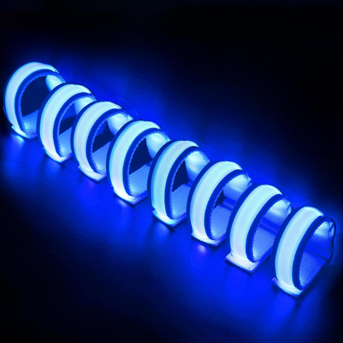 Eight FANL blue LED glow bracelets lit against a dark blue background